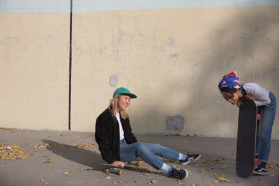 Two young women with skateboards