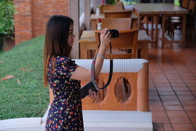 Woman photographing in restaurant