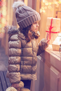 Girl looking at christmas gifts in shop