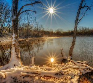 Scenic view of frozen lake against sky during sunset