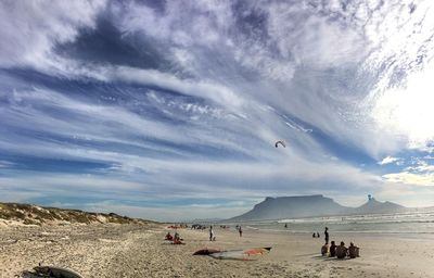 Scenic view of beach against cloudy sky