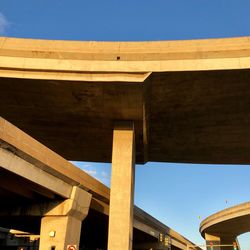 Low angle view of bridge against clear blue sky