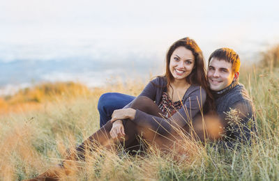 Couple sitting on grass outdoors