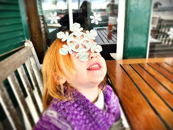 Close-up of girl playing with artificial snowflake at table