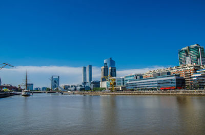 Puente de la mujer bridge over river in city