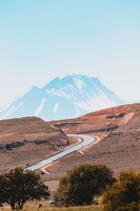 Scenic view of mountains against clear blue sky