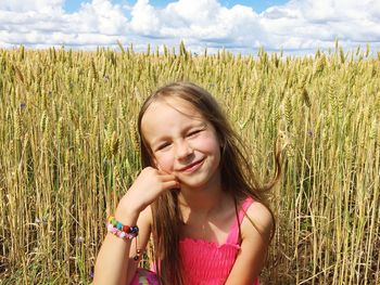 Smiling young woman in field