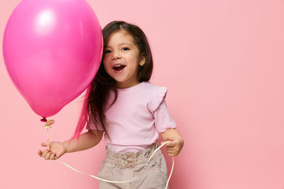 Close-up of balloons against pink background