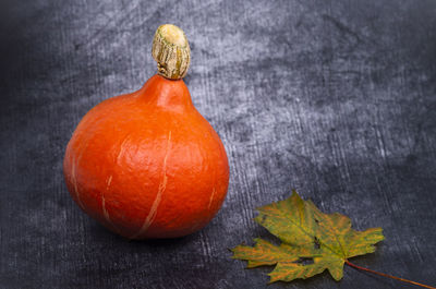 Close-up of pumpkin on wooden table during autumn