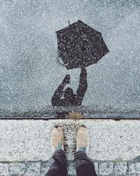 Man standing in puddle