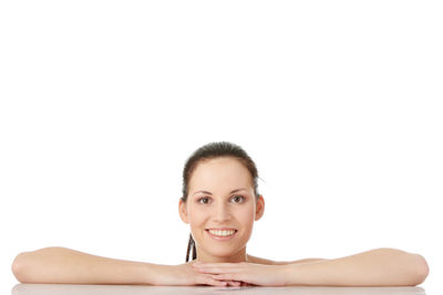 Portrait of a smiling young woman over white background