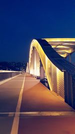 Empty road with bridge in background