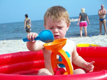 Boy playing with toy on beach