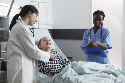 Doctor examining patient in hospital