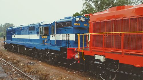 Train on railroad tracks against clear sky