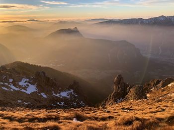 Scenic view of snowcapped mountains against sky during sunset