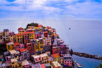 High angle view of townscape by sea against sky