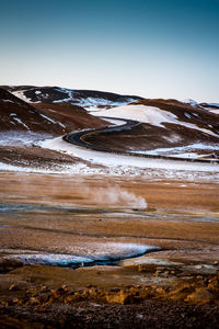 Scenic view of snowcapped mountains against clear sky