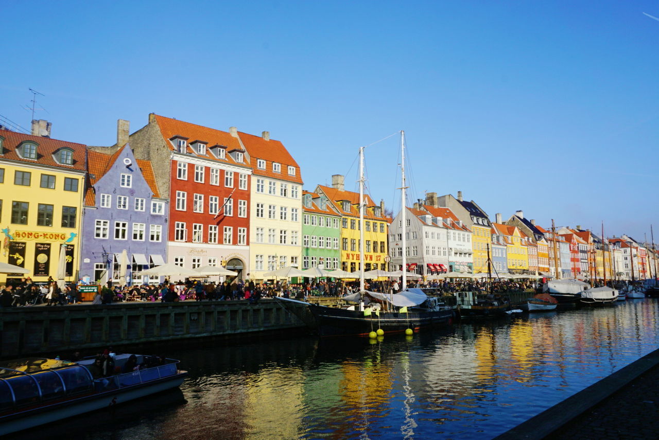 water, building exterior, architecture, built structure, nautical vessel, transportation, clear sky, moored, mode of transport, boat, canal, waterfront, reflection, river, city, blue, copy space, residential structure, residential building, harbor