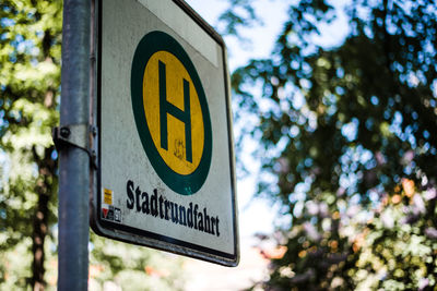 Low angle view of road sign against trees