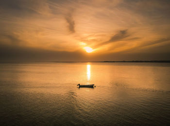 An alone boat witness a beautiful sunset