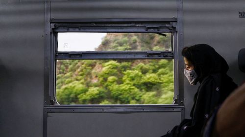 Portrait of woman seeing through train window