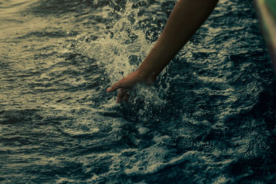Low section of woman in sea