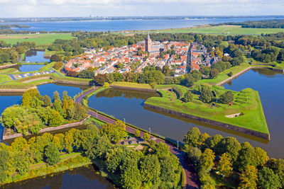 High angle view of trees and buildings against sky