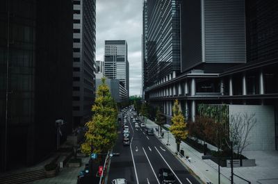 Vehicles on road amidst buildings in city