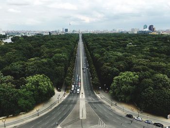 Highway amidst trees against sky