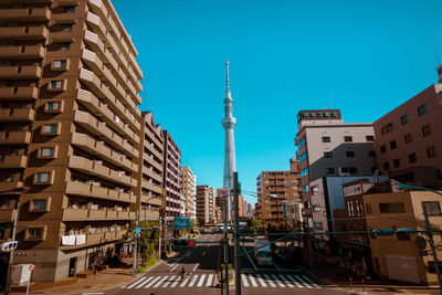 View of residential buildings against blue sky