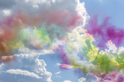 Low angle view of rainbow against cloudy sky