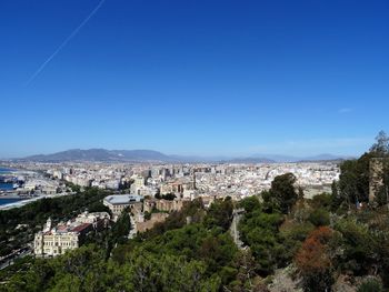 View of cityscape against clear blue sky