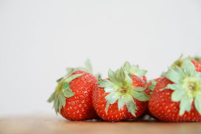 Close-up of chopped strawberries against white background