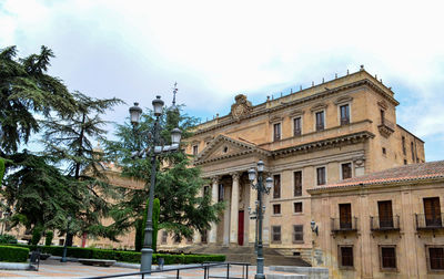 Low angle view of building against cloudy sky