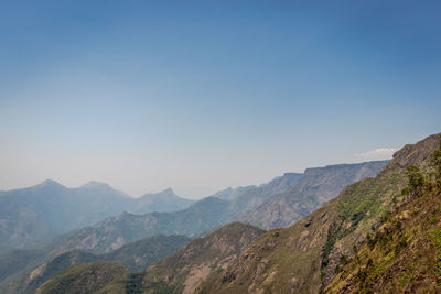 Scenic view of mountains against clear blue sky