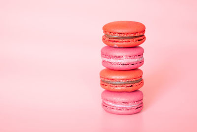 Close-up of multi colored candies against pink background