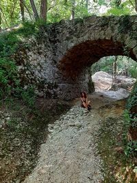 Woman standing on rock in forest