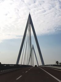 Low angle view of suspension bridge against sky