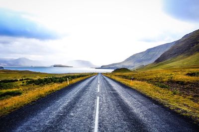 Country road leading towards mountains