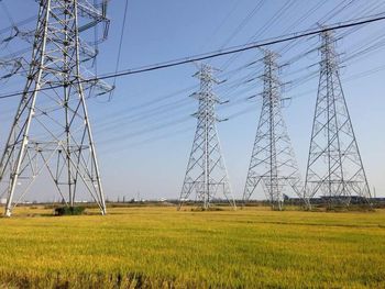 Electricity pylon on field