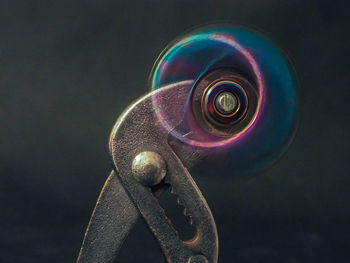 Close-up of spiral object over black background