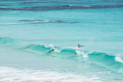 High angle view of man with surfboard on sea