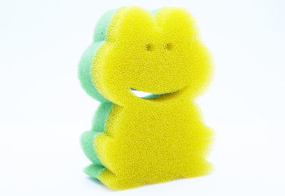 Close-up of yellow toy against white background