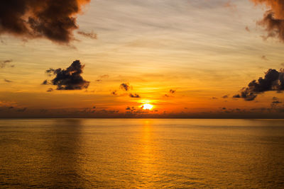 Scenic view of sea against orange sky