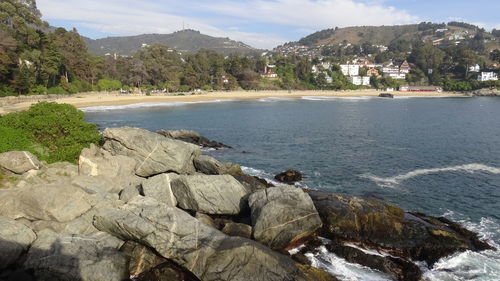 Rocks by sea against sky