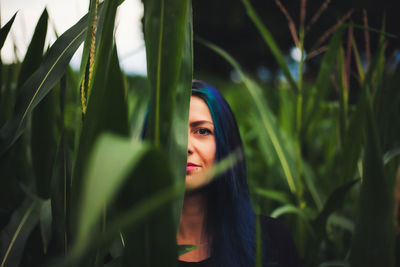 Portrait of woman by plants