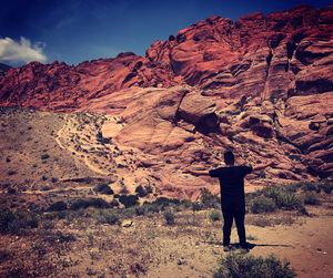 Rear view of man standing on rock