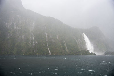 Scenic view of sea by mountains