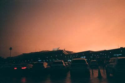 People in town square against sky during sunset